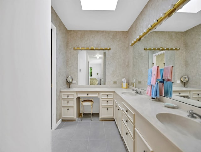 bathroom featuring tile floors, dual bowl vanity, and a skylight