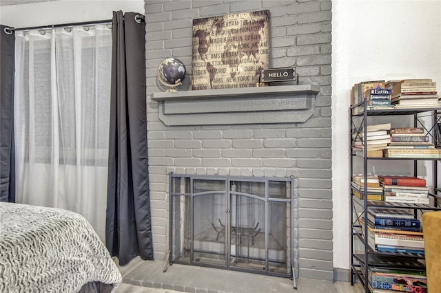 bedroom featuring a brick fireplace