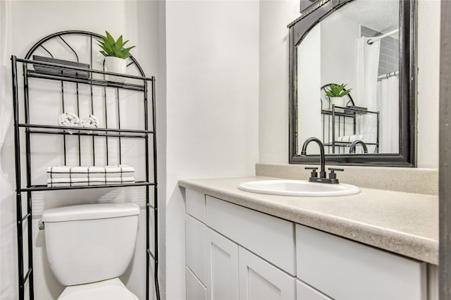 bathroom featuring toilet and oversized vanity