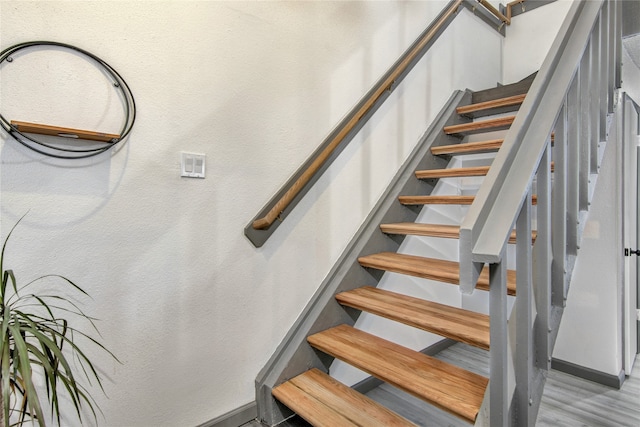 stairs featuring light hardwood / wood-style floors