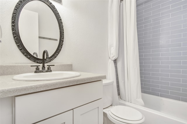 full bathroom featuring shower / bath combo, oversized vanity, and toilet