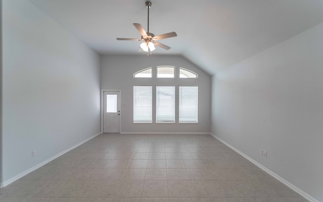 tiled empty room with ceiling fan and lofted ceiling