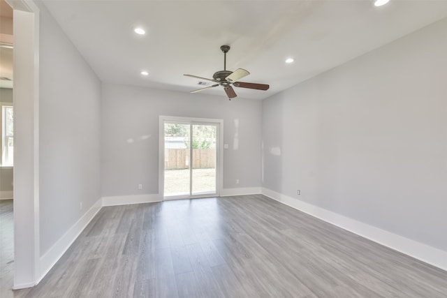 empty room featuring ceiling fan and light hardwood / wood-style flooring