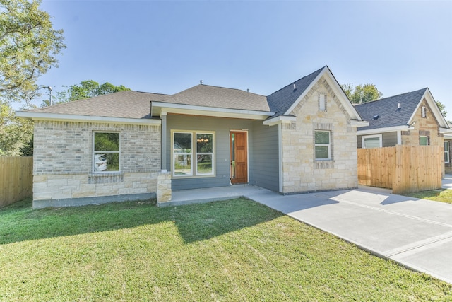 view of front of house featuring a front yard and a patio area