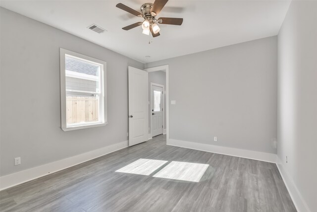 empty room featuring ceiling fan and light wood-type flooring