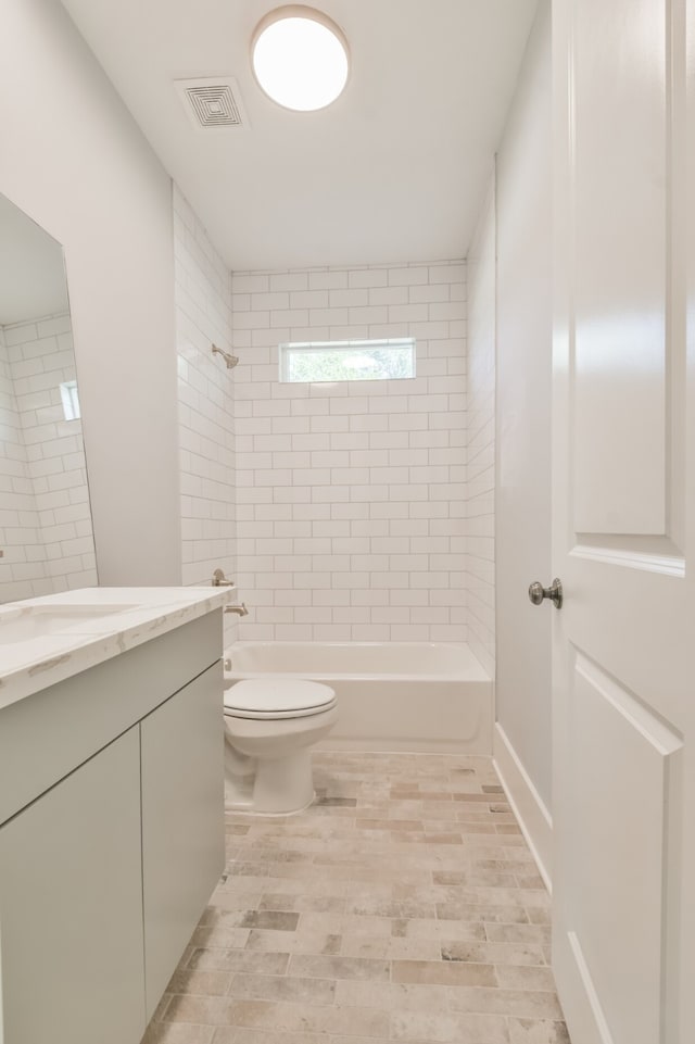 full bathroom featuring hardwood / wood-style flooring, toilet, vanity, and tiled shower / bath