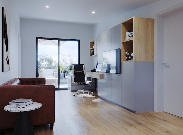 home office with light hardwood / wood-style floors