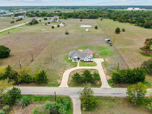 birds eye view of property with a rural view