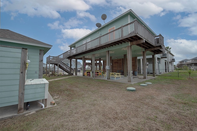 back of house with a patio area, a yard, and a wooden deck