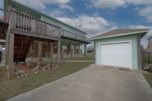 view of front of house featuring a garage, a deck, and a front yard