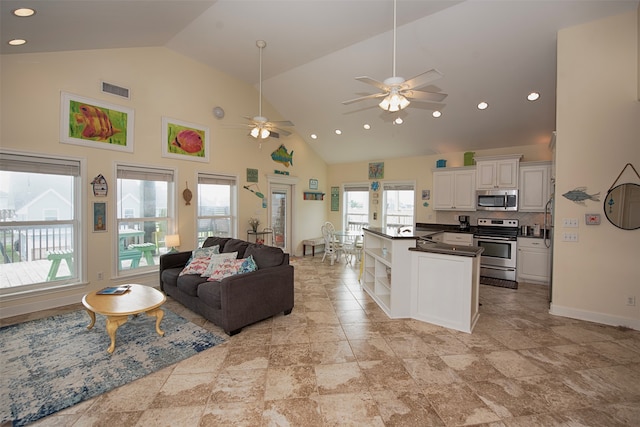 tiled living room featuring high vaulted ceiling and ceiling fan