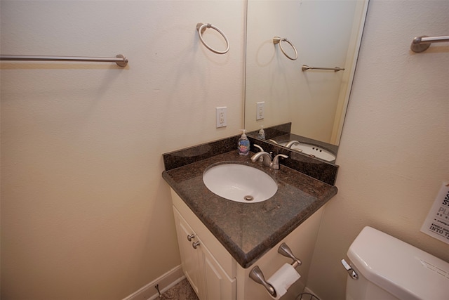 bathroom featuring oversized vanity and toilet