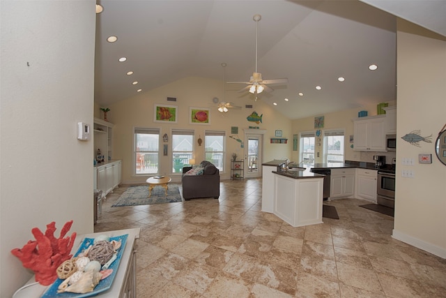 kitchen featuring ceiling fan, plenty of natural light, stainless steel appliances, and white cabinets