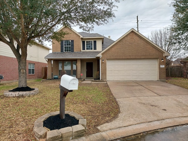 view of property featuring a garage and a front yard