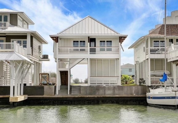 back of property featuring a water view