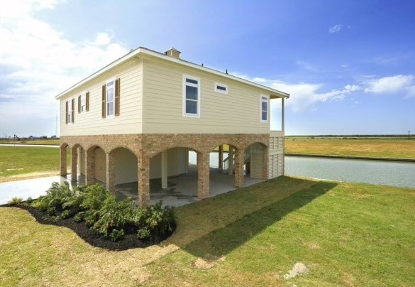 view of property exterior featuring a carport and a lawn