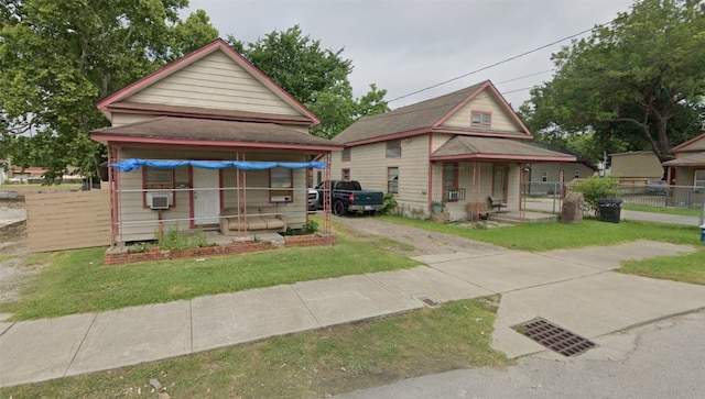 bungalow-style home with a front yard