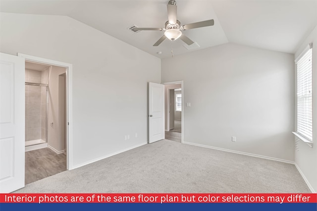 carpeted empty room with vaulted ceiling and ceiling fan