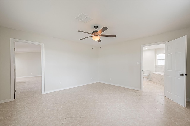 spare room featuring ceiling fan and light tile patterned floors