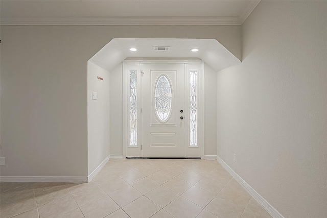 tiled entryway featuring ornamental molding