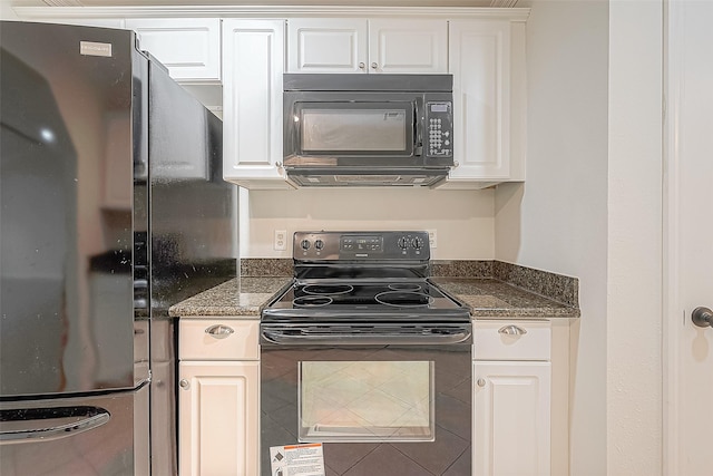 kitchen featuring white cabinets, dark stone countertops, and black appliances