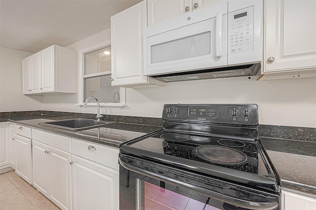 kitchen with white cabinets, light tile patterned floors, black range with electric stovetop, and sink