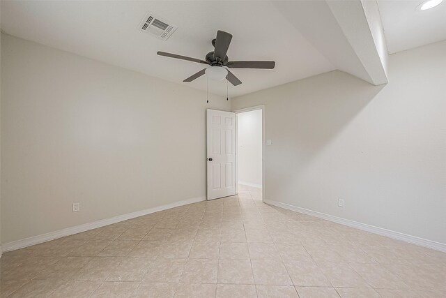 spare room featuring light tile patterned flooring and ceiling fan