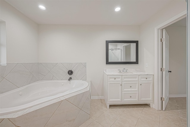 bathroom with vanity, tiled bath, and tile patterned floors