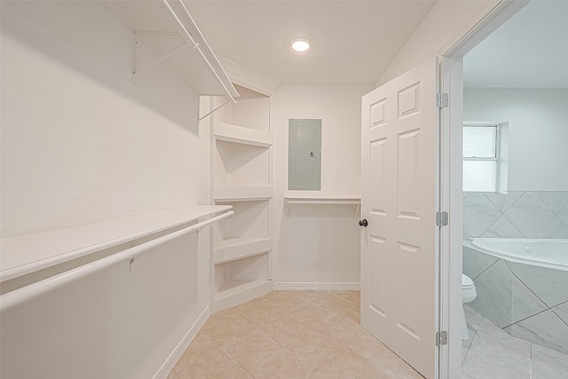 walk in closet featuring electric panel and light tile patterned floors