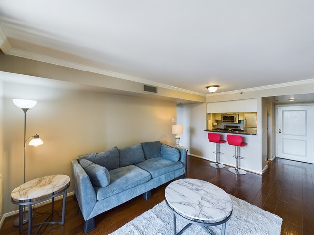 living room with crown molding and dark hardwood / wood-style floors