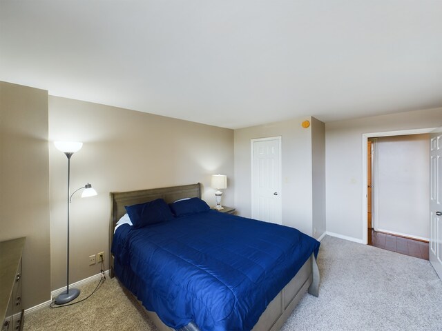 bedroom featuring light colored carpet