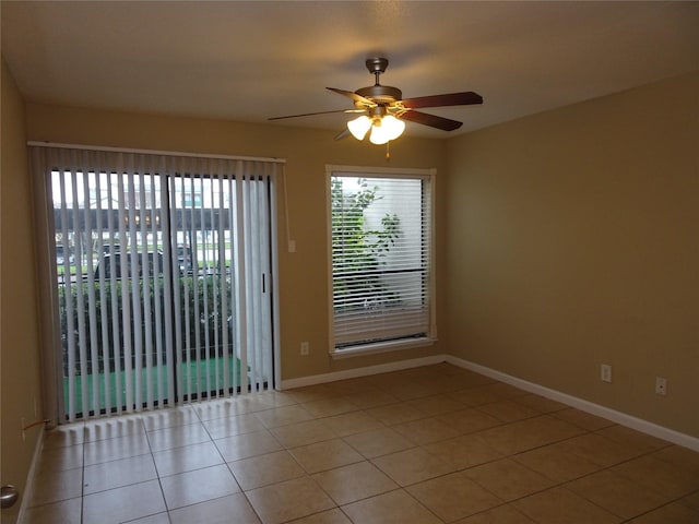 spare room featuring ceiling fan and light tile patterned floors