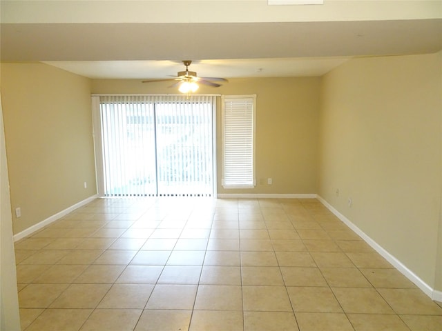 unfurnished room featuring light tile patterned floors and ceiling fan