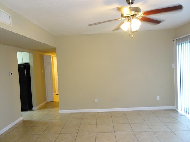 empty room featuring light tile patterned floors and ceiling fan