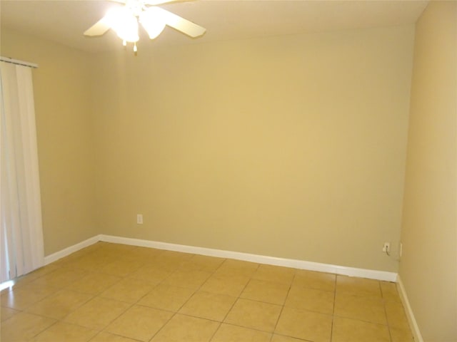 spare room with tile patterned floors and ceiling fan