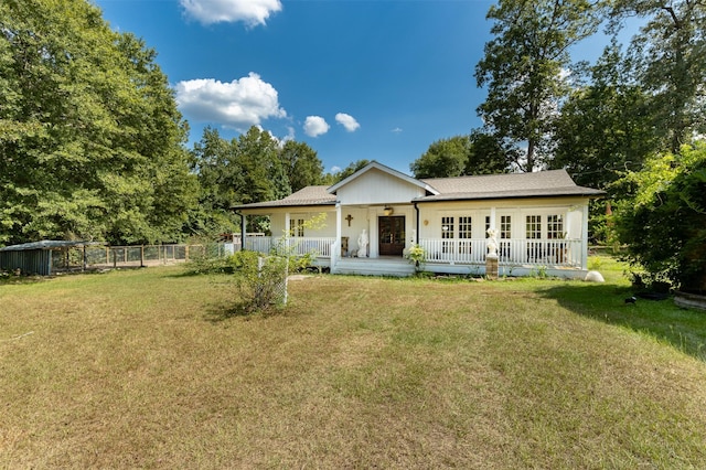 back of house with a lawn, french doors, and covered porch