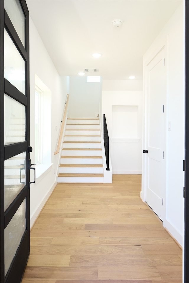 stairs with wood-type flooring