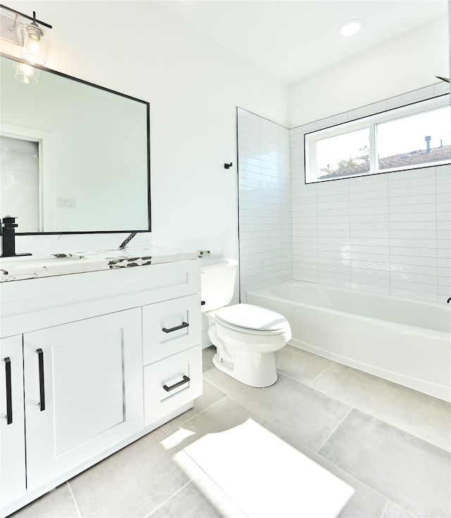 full bathroom featuring tiled shower / bath combo, tile patterned floors, vanity, and toilet