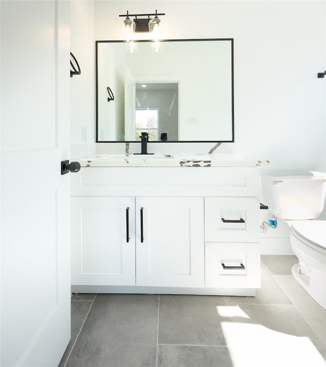 bathroom featuring tile patterned flooring, vanity, and toilet