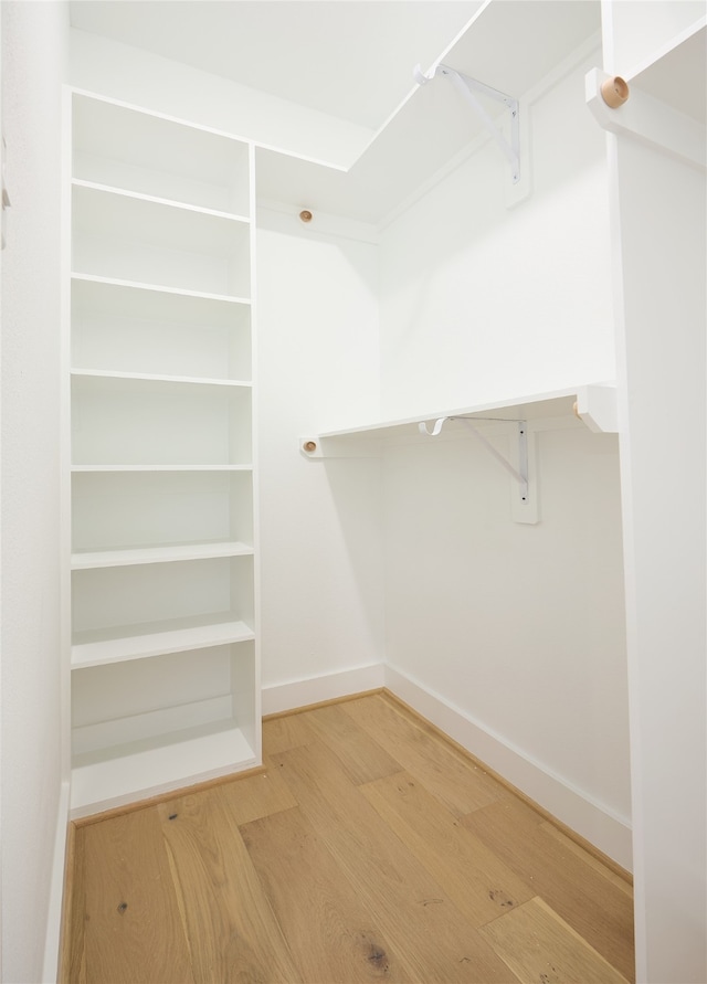 spacious closet featuring hardwood / wood-style flooring