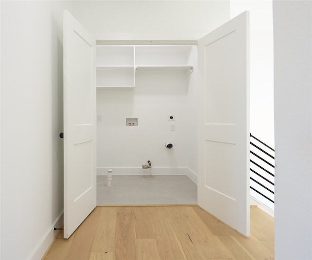 clothes washing area with washer hookup, gas dryer hookup, hookup for an electric dryer, and wood-type flooring