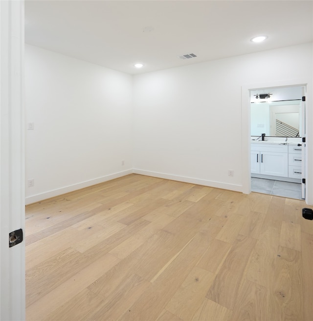 unfurnished room with light wood-type flooring