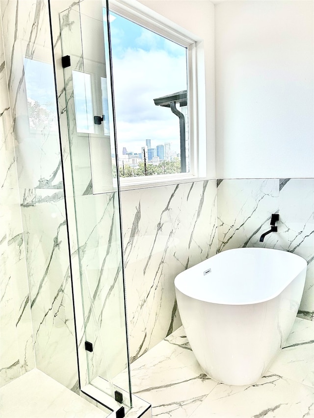 bathroom featuring a wealth of natural light, tile walls, and shower with separate bathtub