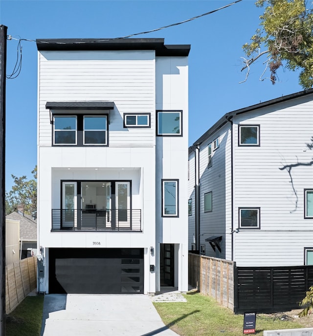 contemporary home featuring a balcony and a garage