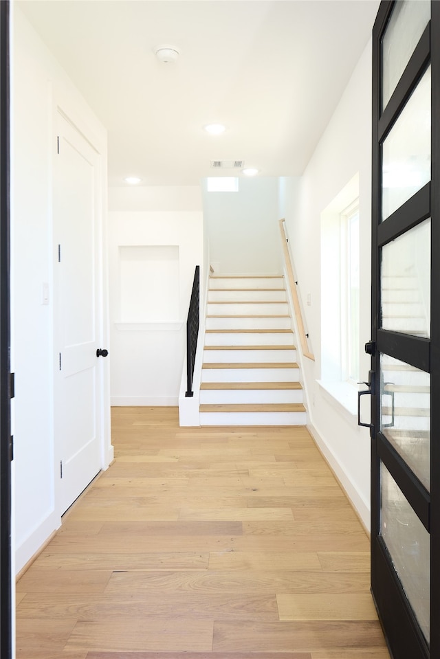 stairs with hardwood / wood-style floors