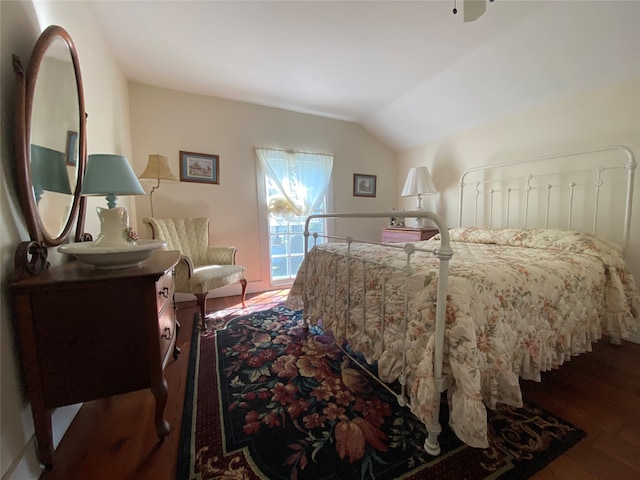 bedroom featuring lofted ceiling and dark wood-type flooring