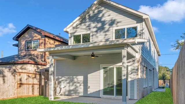 rear view of house featuring ceiling fan