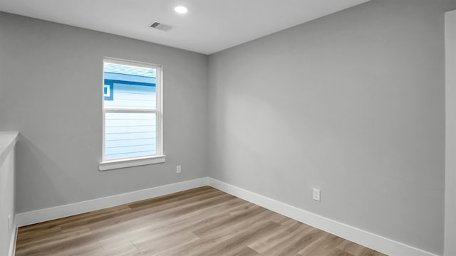 spare room with light hardwood / wood-style flooring