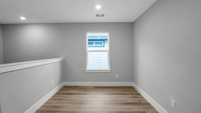 unfurnished room featuring light hardwood / wood-style floors