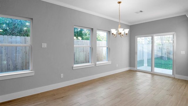 unfurnished room with light hardwood / wood-style floors, ornamental molding, and an inviting chandelier